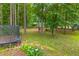 Wooded backyard with trampoline and shed at 121 Orchard Dr, Temple, GA 30179