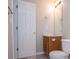 Neat bathroom, with wood vanity and toilet at 121 Orchard Dr, Temple, GA 30179