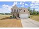 Two-story house with a two-car garage and manicured lawn at 15 Lisa Ct, Covington, GA 30016