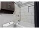 Updated bathroom features tub, shower, modern fixtures, and storage cabinet at 395 Pharr Ne Rd # 207, Atlanta, GA 30305
