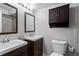 Bathroom featuring double sinks, vanity, mirror, updated fixtures, and toilet at 395 Pharr Ne Rd # 207, Atlanta, GA 30305