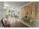 Hallway featuring tiled floor, painted brick walls, and ornate table at 395 Pharr Ne Rd # 207, Atlanta, GA 30305