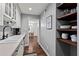 Functional kitchenette space with dark wood shelving and white cabinets at 395 Pharr Ne Rd # 207, Atlanta, GA 30305