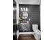 Stylish powder room with black marble countertop and modern fixtures at 7110 Brandon Mill, Sandy Springs, GA 30328