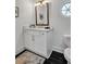 Elegant half bathroom featuring a marble vanity, black tile floors, and gold fixtures at 7110 Brandon Mill, Sandy Springs, GA 30328