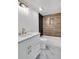 Modern bathroom boasts a stylish vanity, marble floors, and a tiled tub with shower at 7110 Brandon Mill, Sandy Springs, GA 30328