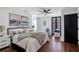 Bright main bedroom with large bed, paintings, and a ceiling fan at 7110 Brandon Mill, Sandy Springs, GA 30328
