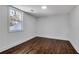 Bright bedroom featuring hardwood floors, fresh paint, and a large window with natural light at 7110 Brandon Mill, Sandy Springs, GA 30328