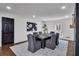 Dining area featuring a large table with seating, stylish decor, and access to the kitchen at 7110 Brandon Mill, Sandy Springs, GA 30328