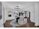 Modern dining room with a black round table and plush neutral chairs at 7110 Brandon Mill, Sandy Springs, GA 30328
