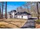 Beautiful two-story home showcasing manicured landscaping, a paved driveway, and white brick exterior at 7110 Brandon Mill, Sandy Springs, GA 30328