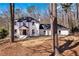 Stunning white-painted brick home with black trim and a new roof in a wooded setting at 7110 Brandon Mill, Sandy Springs, GA 30328