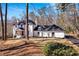 Stately two-story home with a well-manicured lawn, attractive landscaping, and a paved driveway at 7110 Brandon Mill, Sandy Springs, GA 30328