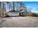 Exterior of a garage with an attached sunroom and a spacious paved driveway at 7110 Brandon Mill, Sandy Springs, GA 30328