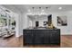 Modern kitchen island with dark cabinets, stainless steel hardware and hardwood floors at 7110 Brandon Mill, Sandy Springs, GA 30328