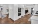 Open kitchen with stainless steel double oven, white cabinetry and hardwood floors at 7110 Brandon Mill, Sandy Springs, GA 30328