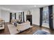 Spacious living room with hardwood floors, a decorative fireplace, and large windows with nice views at 7110 Brandon Mill, Sandy Springs, GA 30328