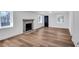 Cozy living room boasts a fireplace, wood-look floors, and natural light through the windows at 7110 Brandon Mill, Sandy Springs, GA 30328