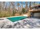 Spacious pool area with a covered pool, surrounded by a concrete deck and wooded backyard at 7110 Brandon Mill, Sandy Springs, GA 30328