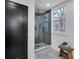 This stylish shower features a frameless glass door and a view from the window at 7110 Brandon Mill, Sandy Springs, GA 30328