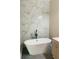 Elegant bathroom featuring a freestanding bathtub and marble tile at 1054 Ira Sw St, Atlanta, GA 30310