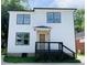 Stunning two-story home features modern design, dark trim, and a deck at 1054 Ira Sw St, Atlanta, GA 30310