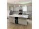 Modern kitchen with granite island, stainless steel appliances, and gray cabinets at 1054 Ira Sw St, Atlanta, GA 30310