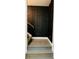 Modern staircase with dark wood and black wall paneling at 1054 Ira Sw St, Atlanta, GA 30310