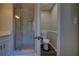 Bathroom featuring a glass shower with a built-in shelf and a separate toilet area at 3640 Autumn View Nw Dr, Acworth, GA 30101