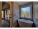 Relaxing bathroom features a soaking tub, private window, neutral paint, and modern fixtures at 3640 Autumn View Nw Dr, Acworth, GA 30101