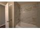 Bright bathroom features a shower with luxurious marble-look tile, a bathtub, and updated hardware at 3640 Autumn View Nw Dr, Acworth, GA 30101