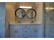 Bathroom featuring double sinks with black framed mirrors and tiled shower at 3640 Autumn View Nw Dr, Acworth, GA 30101