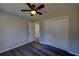 This bedroom features wood-look floors, neutral walls, a ceiling fan, and a double door closet at 3640 Autumn View Nw Dr, Acworth, GA 30101