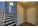 Inviting entryway with stairs featuring white risers and a black trim, and hardwood style flooring at 3640 Autumn View Nw Dr, Acworth, GA 30101