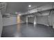 Spacious three car garage featuring painted walls, epoxy floors, and overhead storage racks at 3640 Autumn View Nw Dr, Acworth, GA 30101