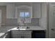 Modern kitchen showcasing stainless steel sink, white counters, cabinets, and undermount dishwasher at 3640 Autumn View Nw Dr, Acworth, GA 30101