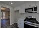 Kitchen boasting sleek stainless steel appliances, white cabinetry and mosaic backsplash at 3640 Autumn View Nw Dr, Acworth, GA 30101