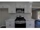Stylish kitchen with white cabinets, stainless steel appliances, and mosaic tile backsplash at 3640 Autumn View Nw Dr, Acworth, GA 30101
