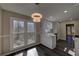 Bright kitchen with stylish chandelier, stainless steel sink, and white cabinetry and countertops at 3640 Autumn View Nw Dr, Acworth, GA 30101
