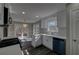 Bright kitchen with stainless steel appliances, hardwood floors, white cabinets, and natural light at 3640 Autumn View Nw Dr, Acworth, GA 30101