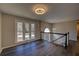 Upstairs living room with hardwood floors, neutral walls, staircase, and lots of natural light at 3640 Autumn View Nw Dr, Acworth, GA 30101