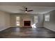 Inviting living room features a cozy fireplace, ceiling fan, and stylish gray wood flooring at 3640 Autumn View Nw Dr, Acworth, GA 30101