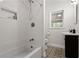 Updated bathroom with subway tile, a shower/tub combo, and patterned floor at 491 Monument Se Ave, Atlanta, GA 30316