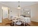 Well-lit dining room with hardwood floors, arched entryway, and a view to the living room at 491 Monument Se Ave, Atlanta, GA 30316