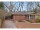 Front view of brick ranch home with carport and screened porch at 491 Monument Se Ave, Atlanta, GA 30316