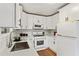 Updated kitchen boasts white cabinets, stainless steel appliances, and quartz countertops at 491 Monument Se Ave, Atlanta, GA 30316