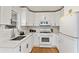 Modern white kitchen with stainless steel appliances and quartz countertops at 491 Monument Se Ave, Atlanta, GA 30316