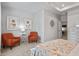 Spacious bedroom with two orange accent chairs and a floral-patterned bed at 205 Bastian Dr # 2, Villa Rica, GA 30180