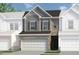 Two-story townhome with gray siding, brick accents, and a two-car garage at 205 Bastian Dr # 2, Villa Rica, GA 30180