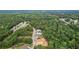 Aerial view showcasing a lush, wooded neighborhood with beautiful homes nestled among the trees at 4267 Matisse Ln, Fairburn, GA 30213